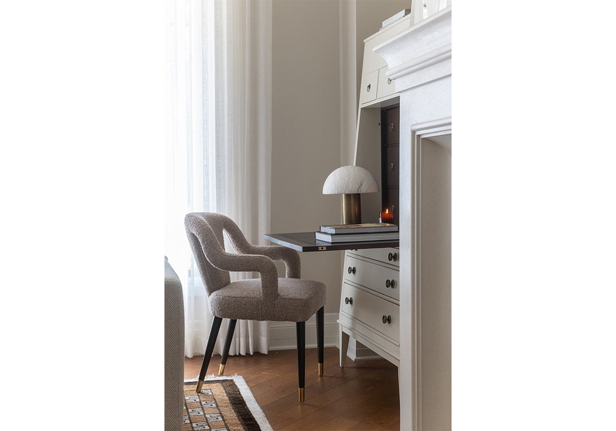 bobbie chair can be seen sitting in front of a dresser/desk with the suxxex rug at the bottom of the photo.
