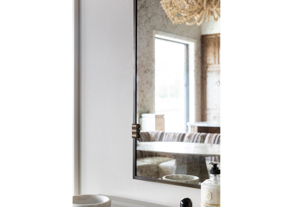 close up of corner of the arlo mirror. with reflection of background.