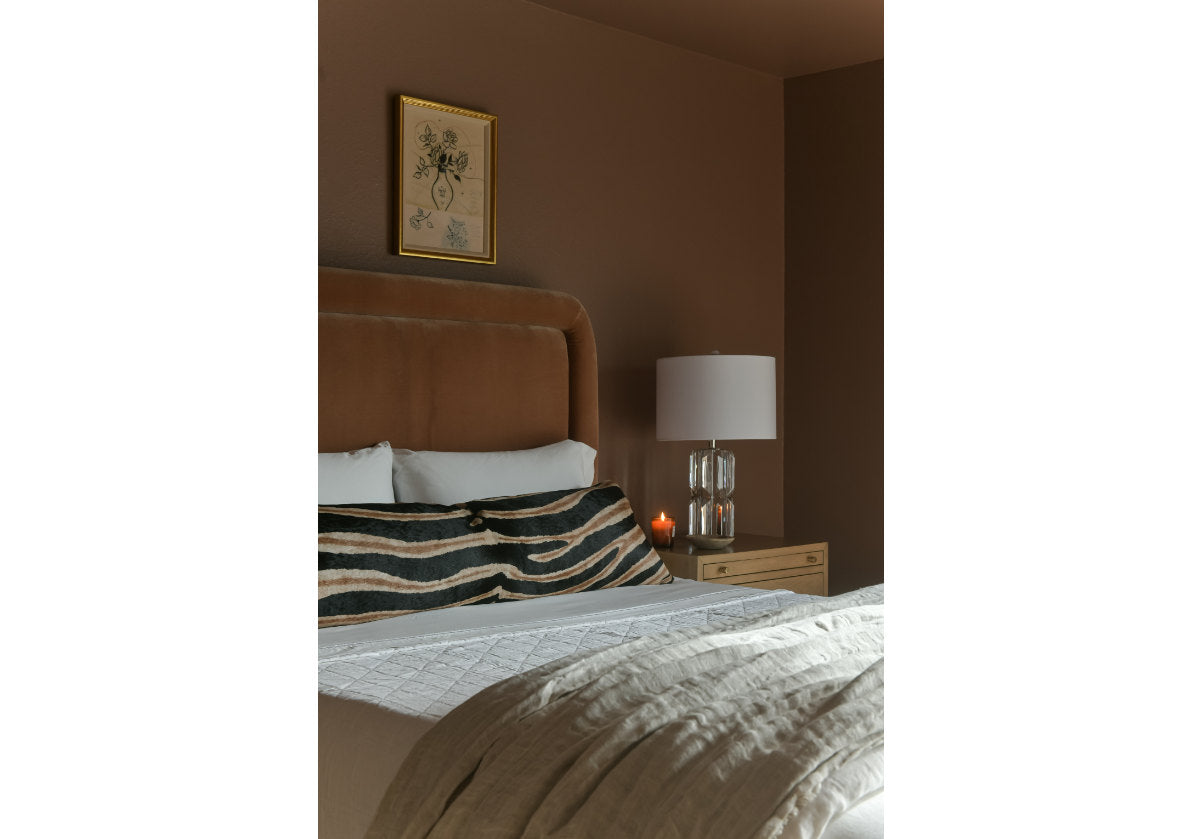 lifestyle shot of the beverly lamp next to a bed.