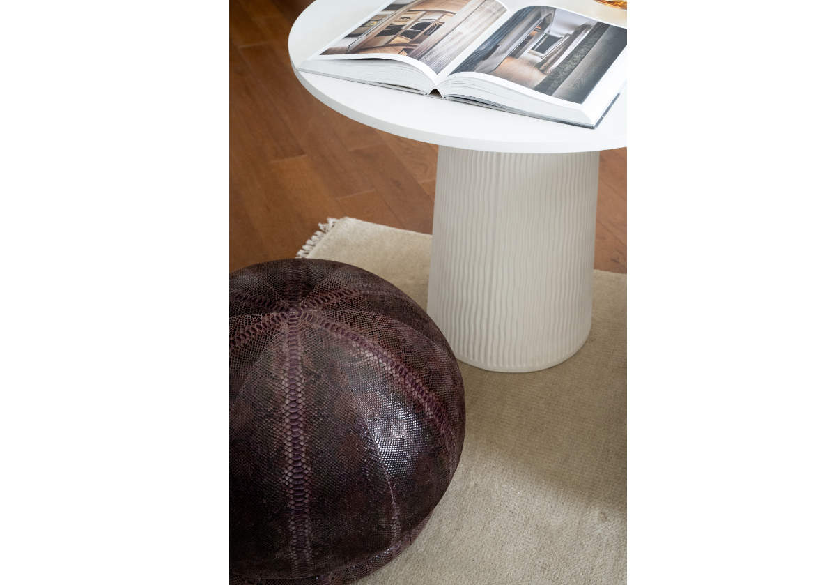 billie snake skin pouf next to lucca side table.