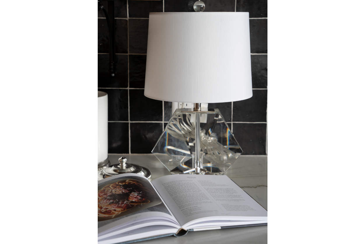 lifestyle photo of the birdie lamp next to a cookbook.