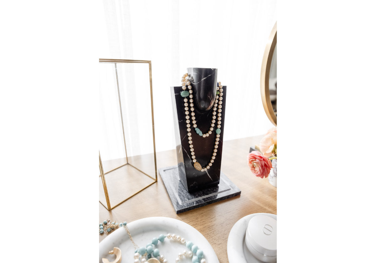 lifestyle photo of the darlen necklace holder and brass glass box.