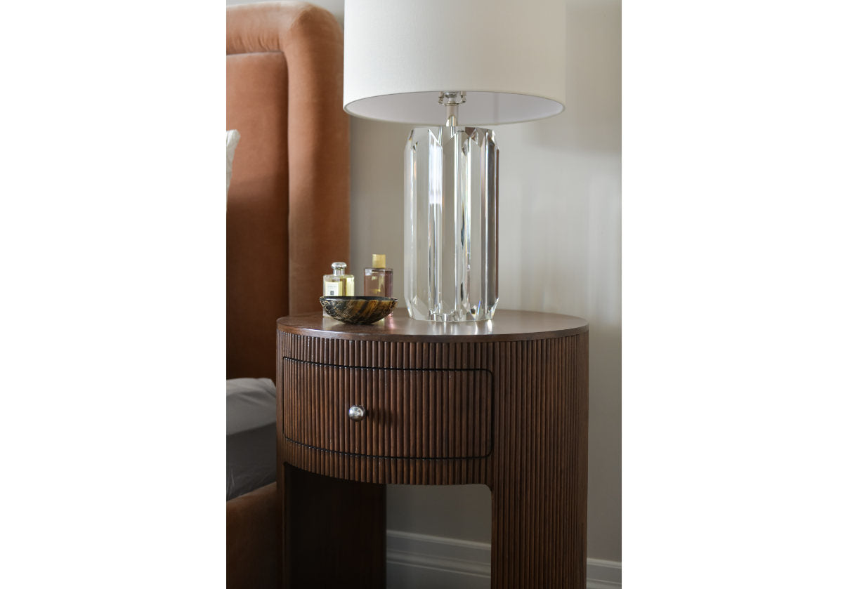 lifestyle photo of the cleo lamp with the beverly lamp next to the kit bed.