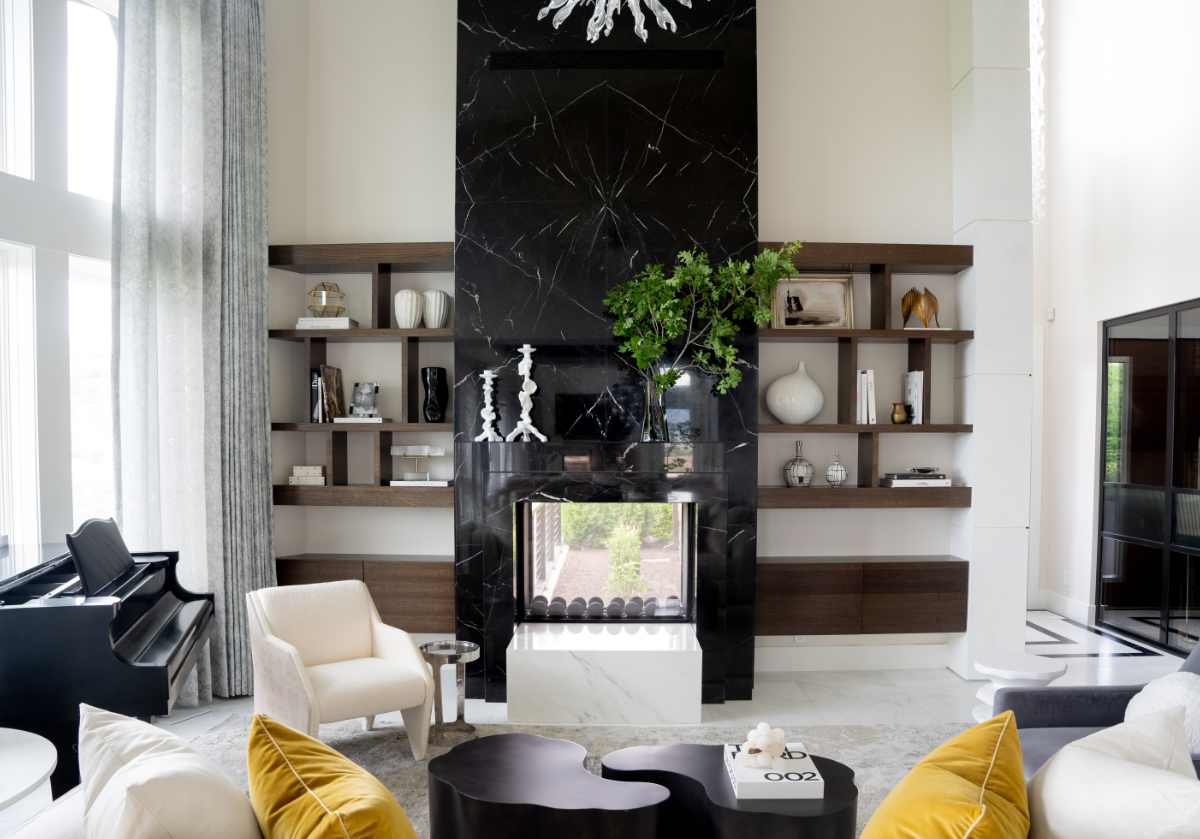 lifestyle photo of black and crystal picture frame on open shelving next to a dark marble fireplace.
