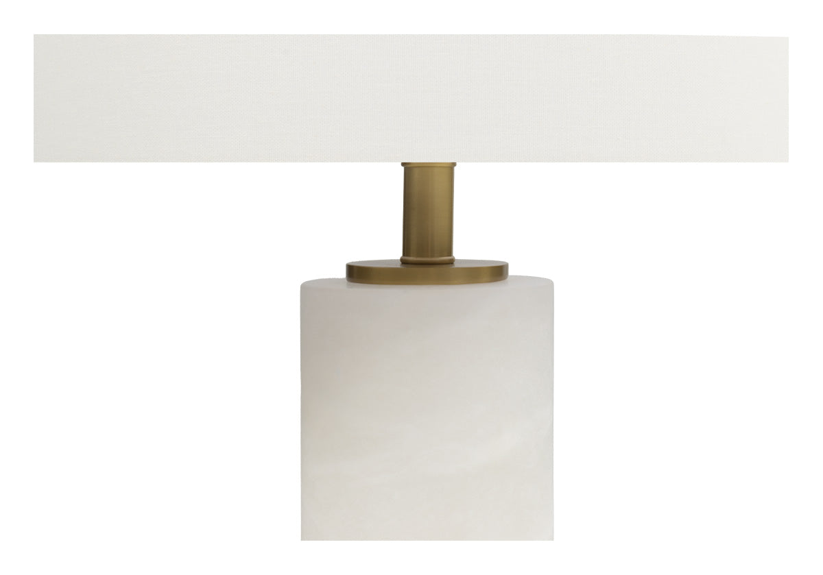 close up of middle of white lamp with gold center and white bottom
