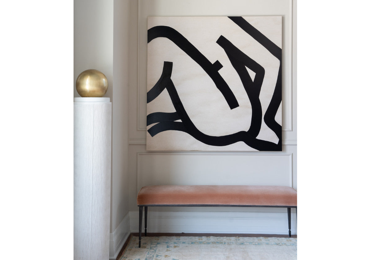 atticus column seen in front of a large painting in a hallway with a velvet bench.