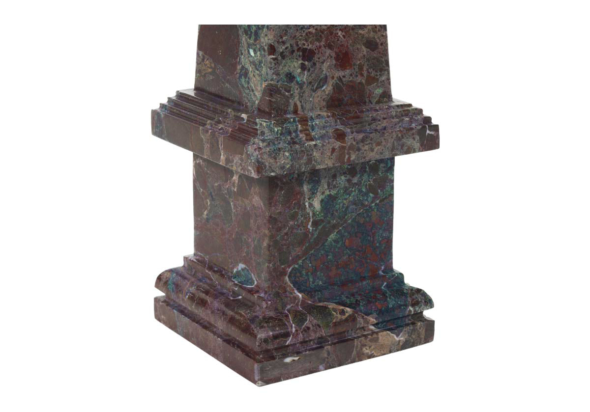 close up photo of base of marble obelisk in oxblood.