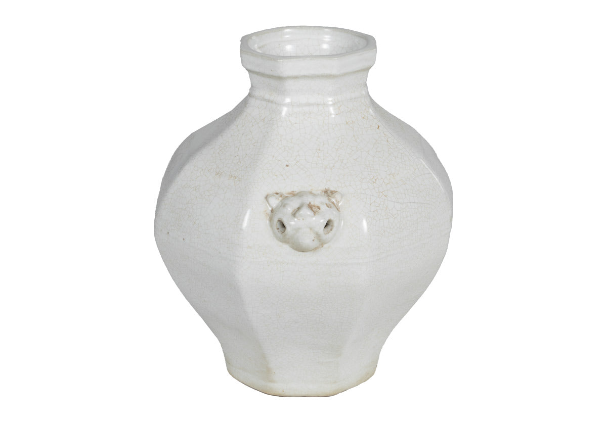 large white jar anmed agnes with designs on the side.