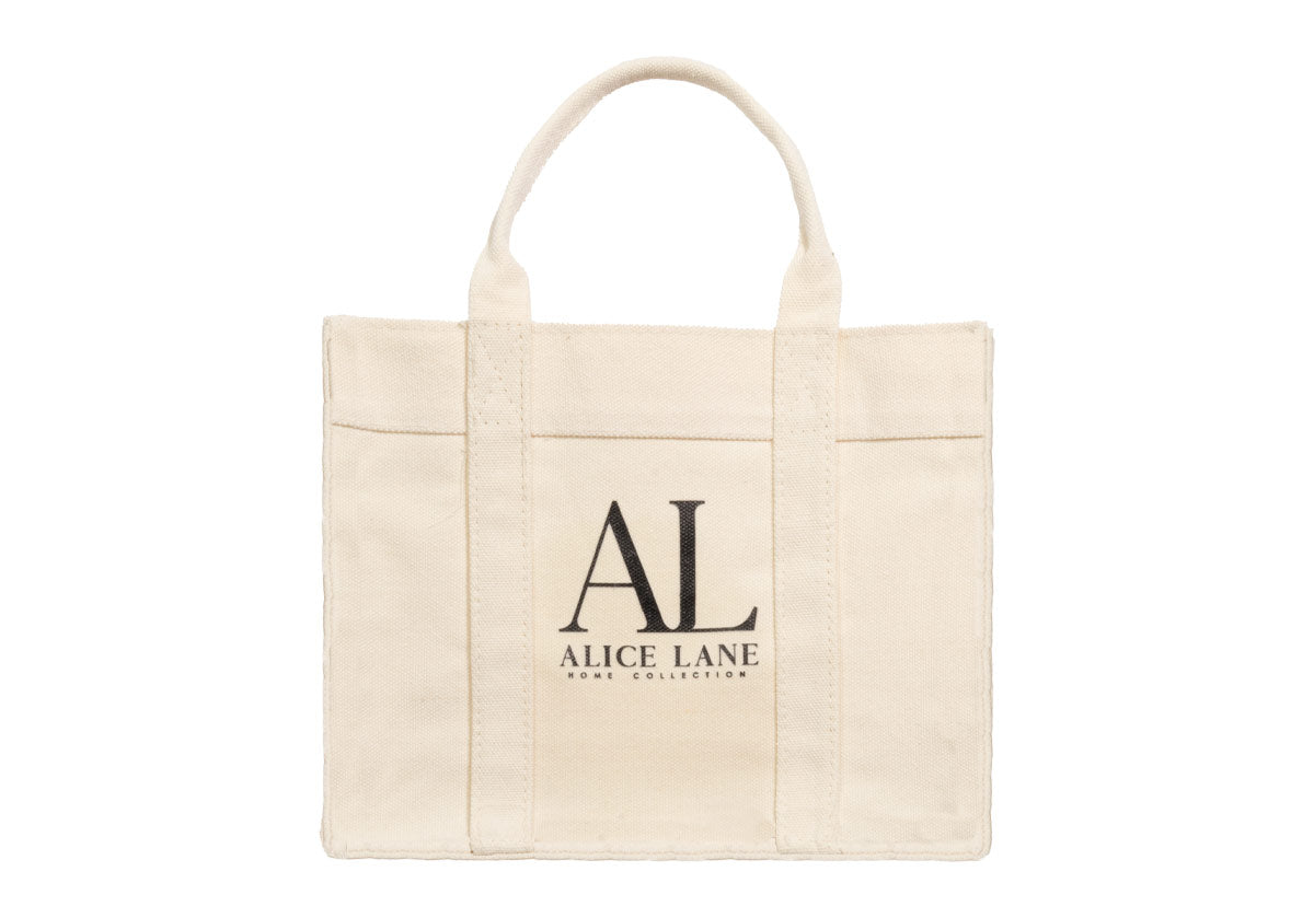 An everyday essential, the Alice Lane Tote bag features a natural, organic canvas color complemented by durable handles. Available in two sizes, it easily carries groceries and new purchases or styles as a purse for wallets and electronics. Side snaps effortlessly provide extended or reduced space, further elevating its functional design. 