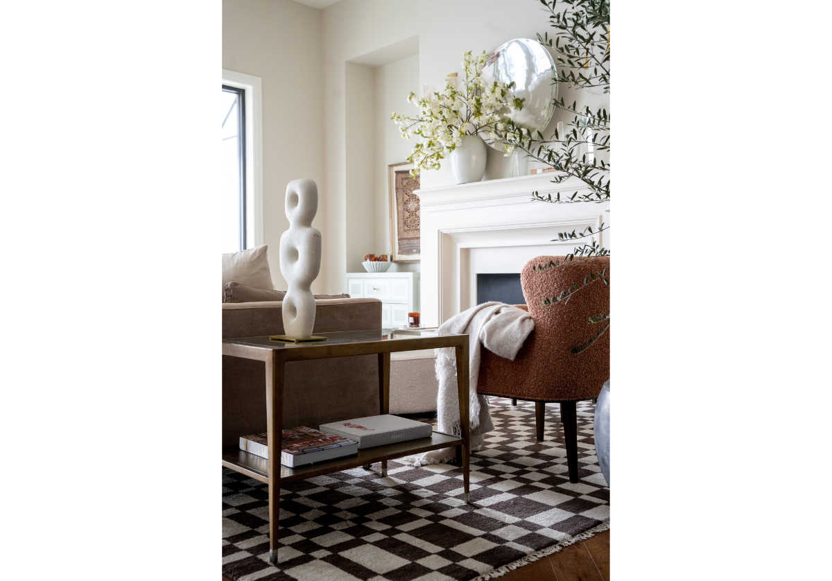 the chess rug with brown and white checkered design with a side table and a sofa with a chair on top of it.