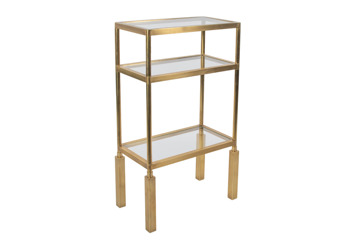 the beatrice brass etagere with glass shelves and brass legs facing the right.