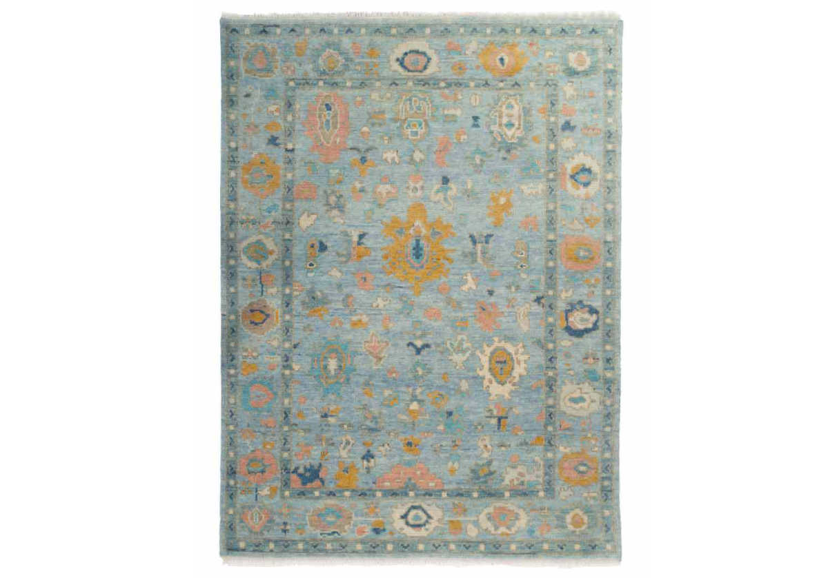 The Daphne showcases a captivating form with its timeless, heirloom patterning accentuated by hues of gold, blue, and pink. Fringed edges lend additional texture, creating a striking, tasteful design. Its hand-knotted form crafted from high-quality wool styles beautifully into bedrooms and living rooms. 