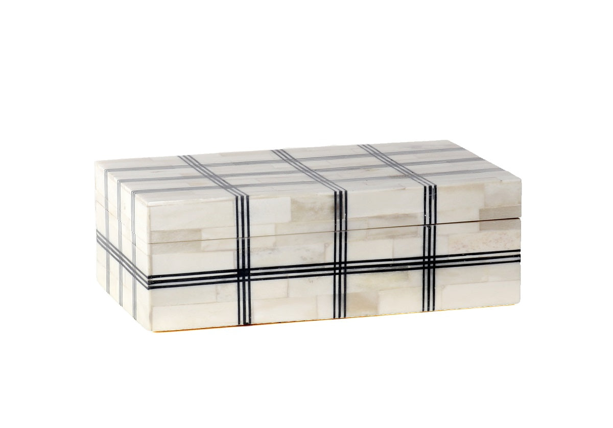 The Domino Plaid Box lends a look of its own, featuring bold black stripes on a natural bone background. This piece creates ample dimension while also providing a catchall for small treasures or jewelry. 