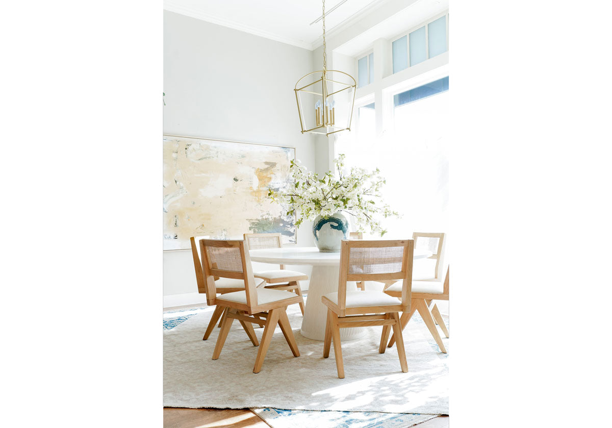 belleview lantern seen floating above the lucca dining table.