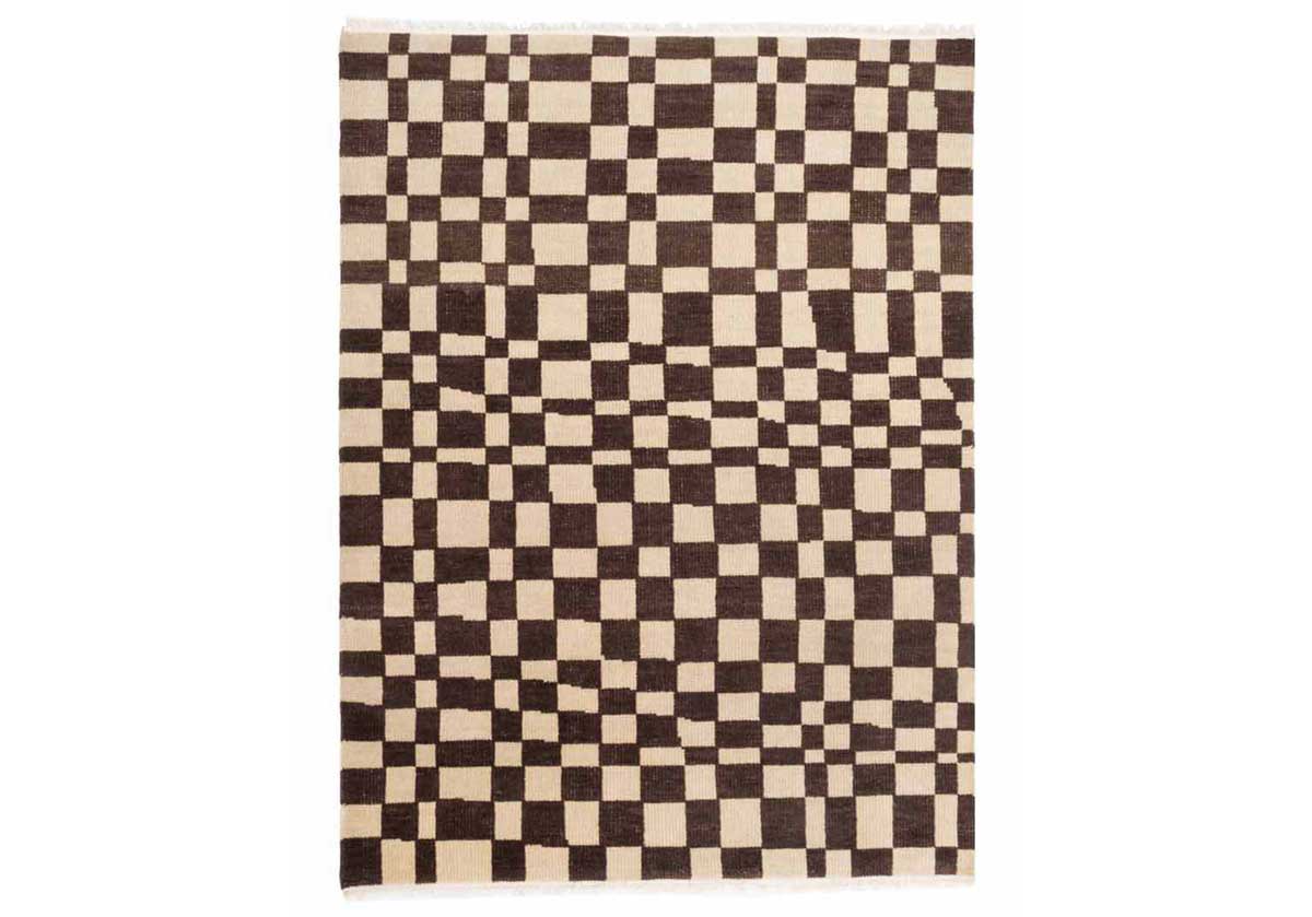 This statement rug boasts incredible visual dimension with its asymmetrical chess pattern. Its versatile brown and natural coloring is complemented by tassel ends, further elevating its tasteful design. Crafted entirely from New Zealand wool, its durable form styles well into entryways, bedrooms, or living rooms lending texture and sophistication. 