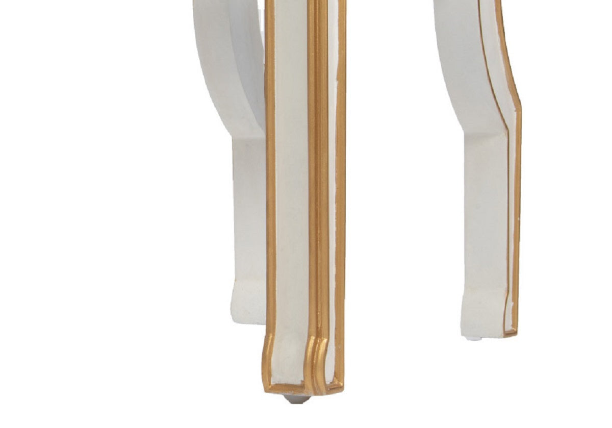 close up of the legs of the felix chair with gold trim.