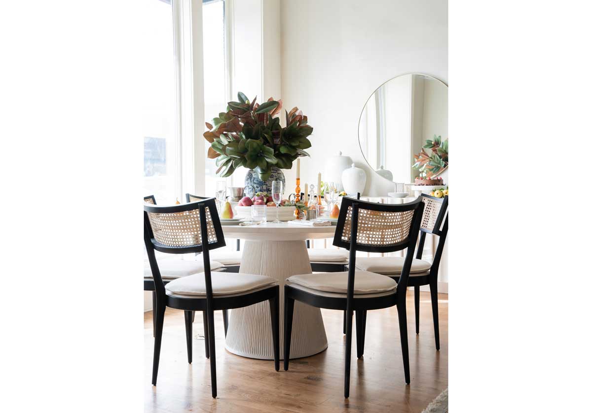 the dancing dragon vase is in the center of the lucca dining table