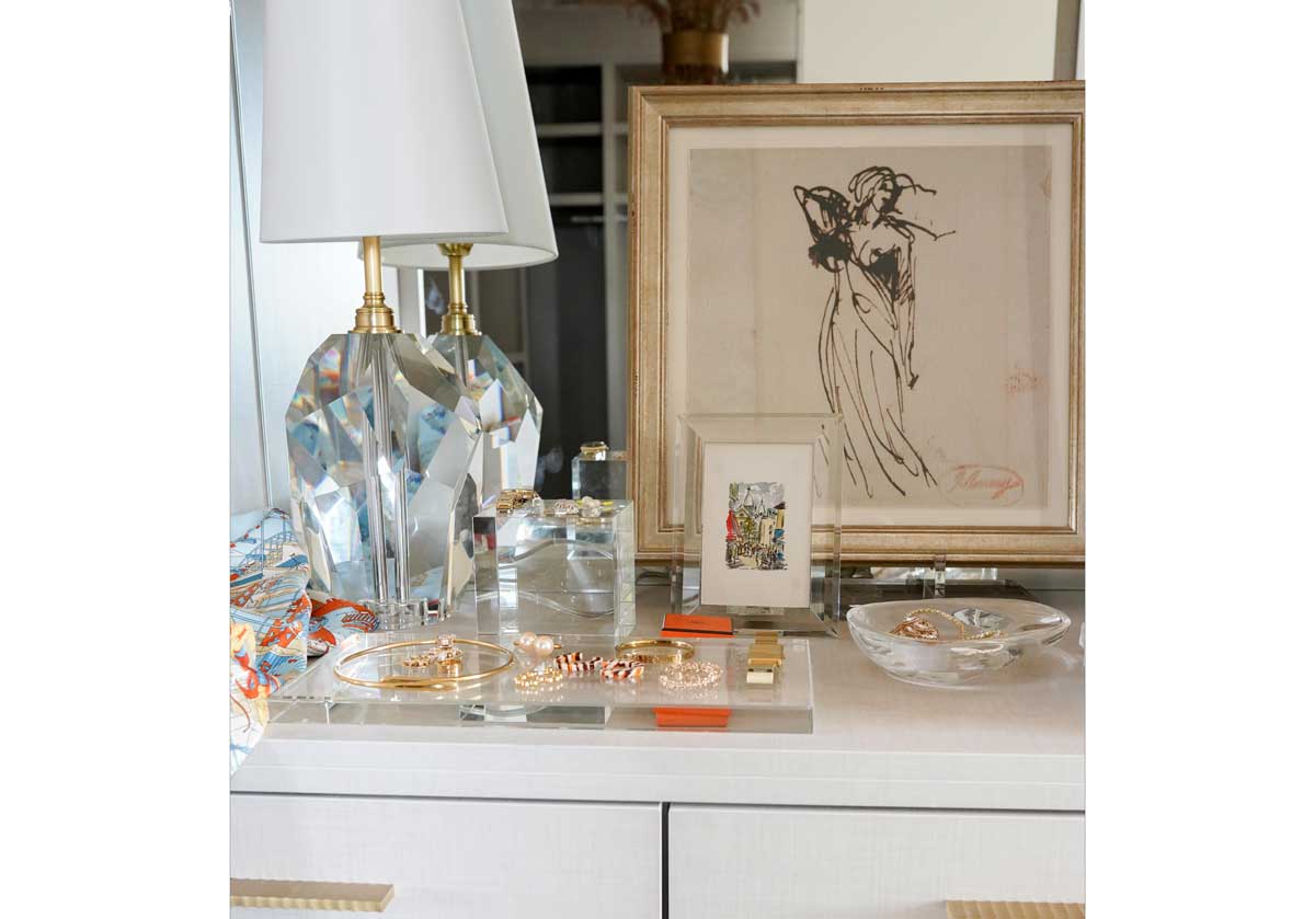 next to a large crystal lamp, is a small crystal cube and frame, slab and tray.