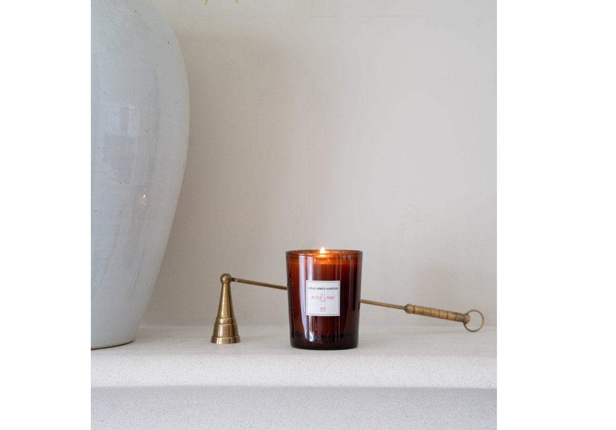 Brass candle pictured with alice lane candle. 