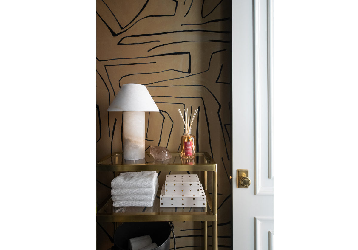 beatrice etagere pictured in a bathroom with an alabaster lamp and bone boxes decorated. 