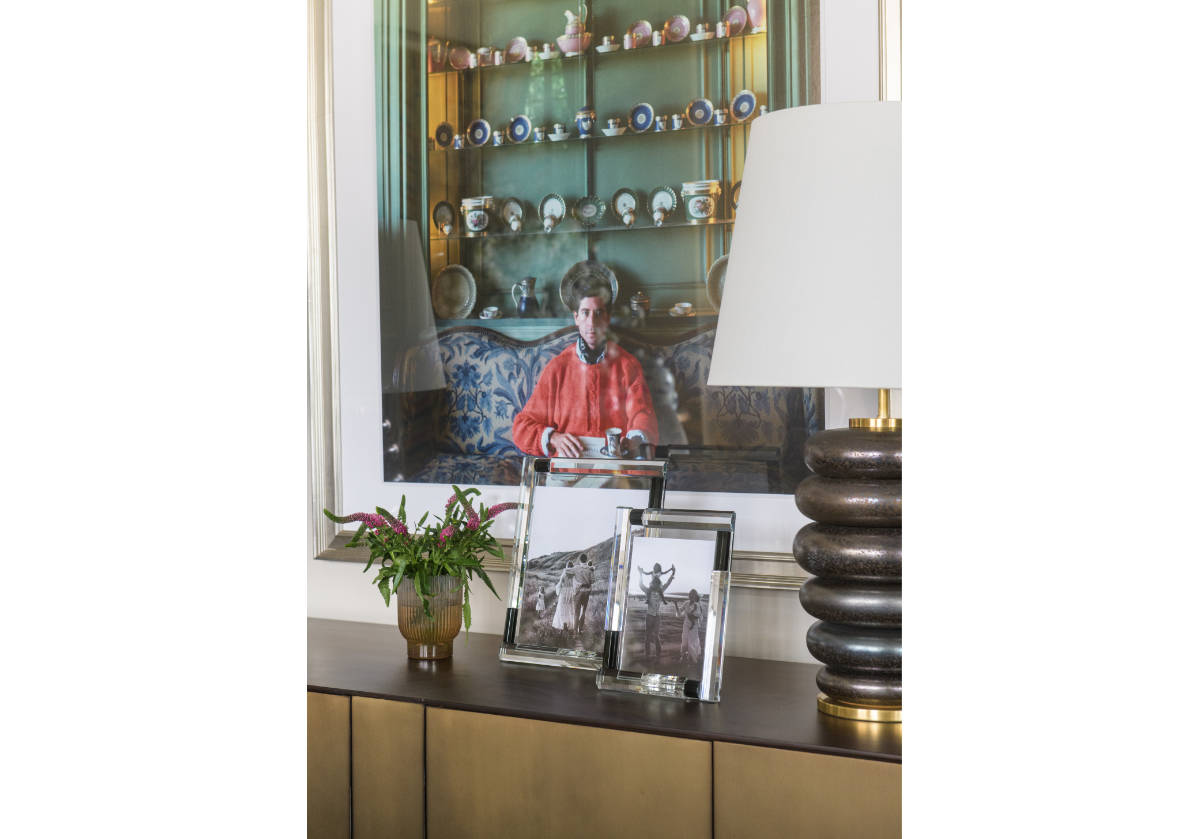 one large and one small black and crystal frames on a cabinet. 