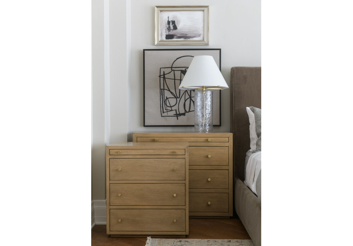 a lifestyle photo of both the brooklyn nightstand and small brooklyn nightstand with a lamp on top of the brooklyn nightstand. 