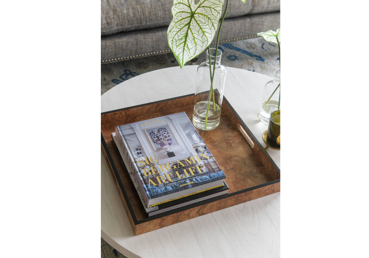 photo of the large square burled wood tray with books and a stem. 