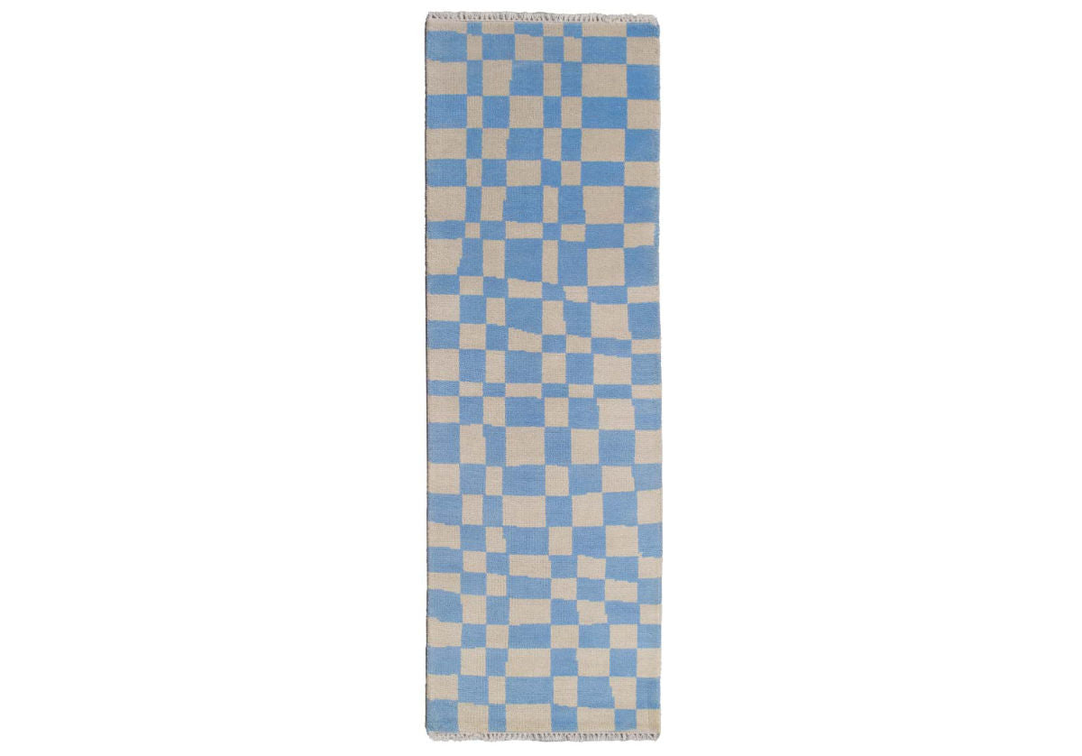 Crafted entirely from New Zealand wool, this rug is one-of-a-kind and completely customizable. Select from a variety of colors and sizing for your own individual style. This statement rug boasts incredible visual dimension with its asymmetrical chess pattern. Its eye-catching coloring is complemented by tassel ends, further elevating its tasteful design.