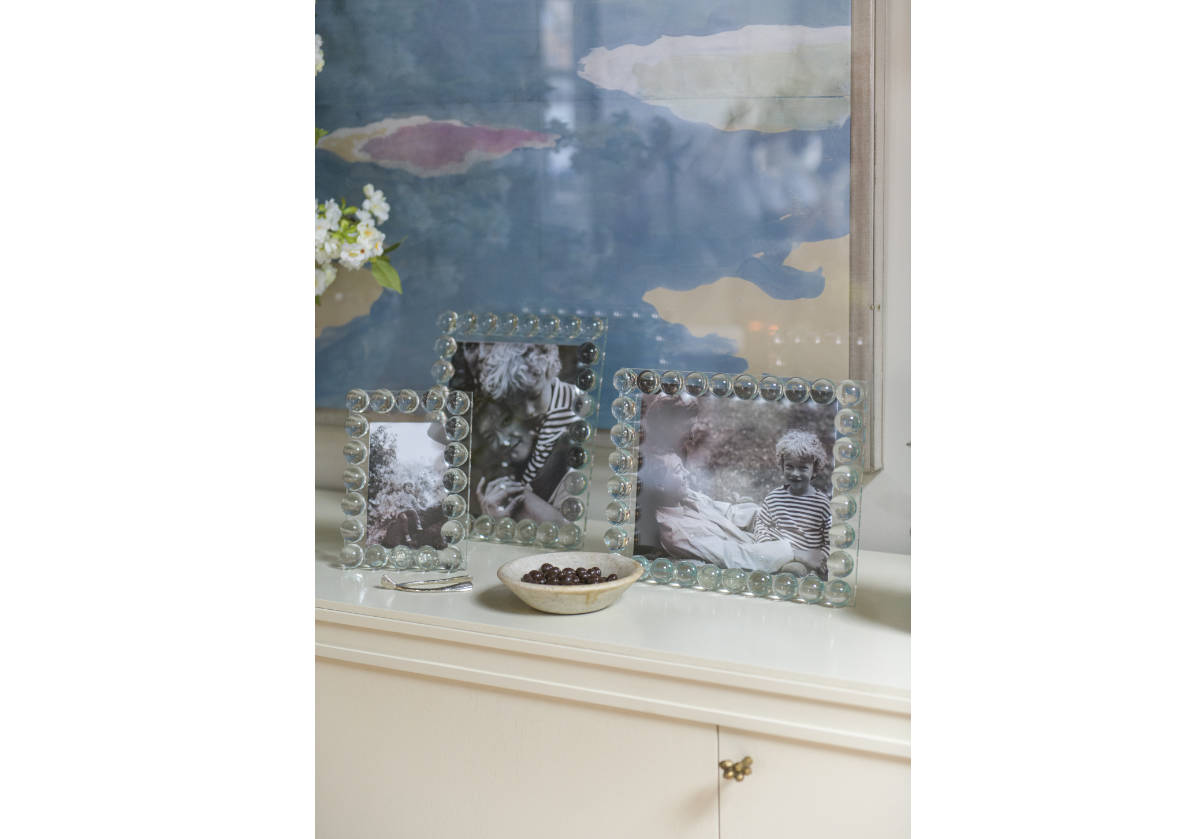 different sized crystal orb frames on a windowsill. 