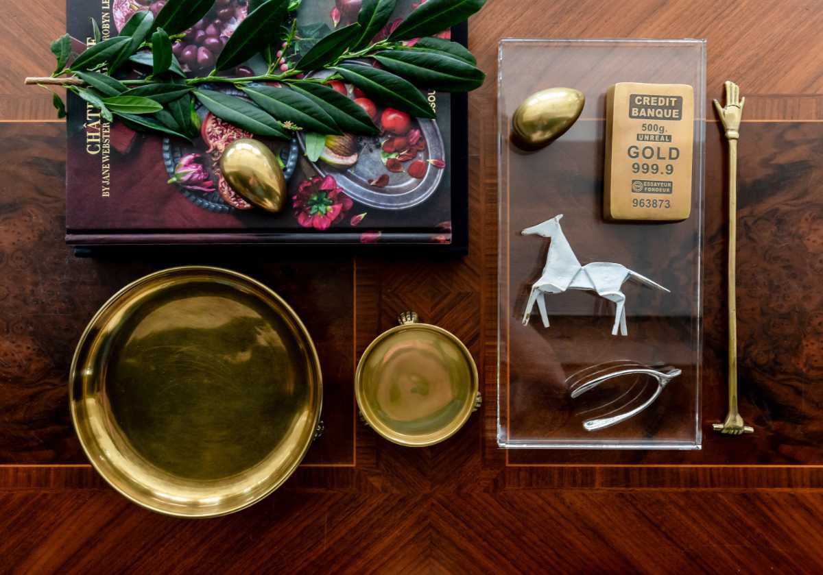 brass horse seen with the other alice lane curiosity collection. brass tray and dish with horse, gold bar, gold egg, and harper hand. 