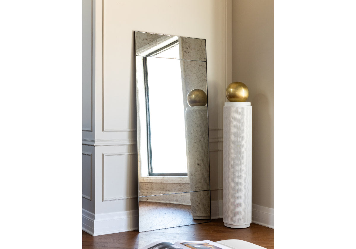 the eden mirror floor and the atticus next to a wainscotted wall. 