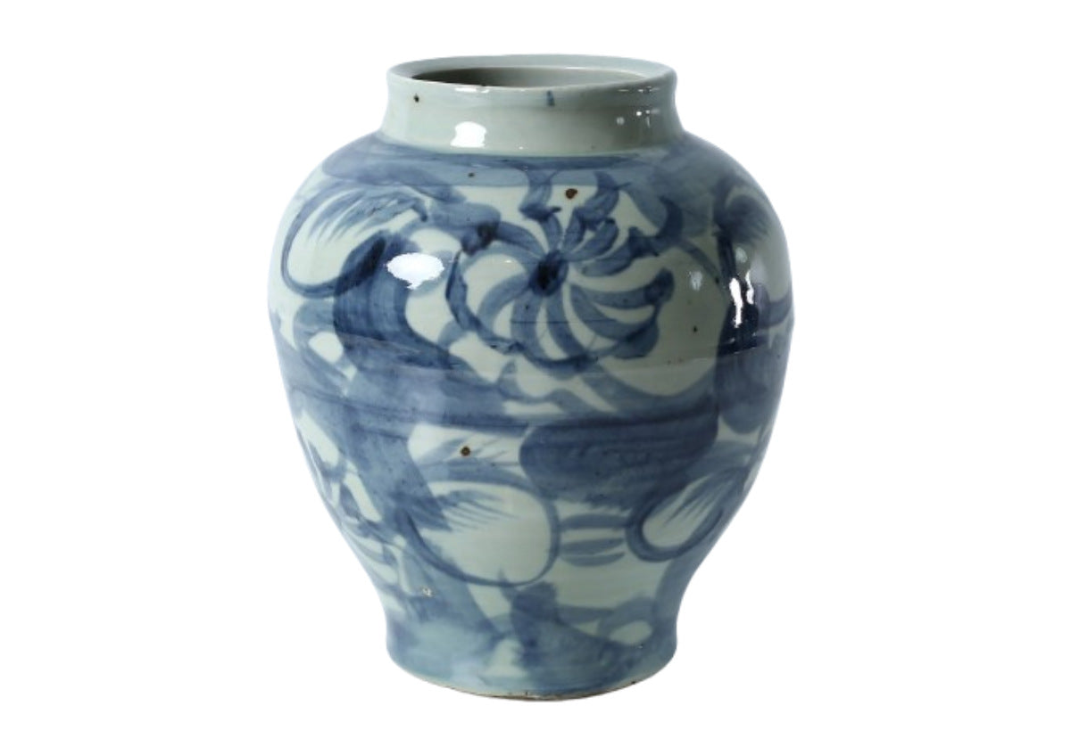 This decorative jar lends a tasteful, playful design. With light blue and white features, accentuating the floral and reed designs. 