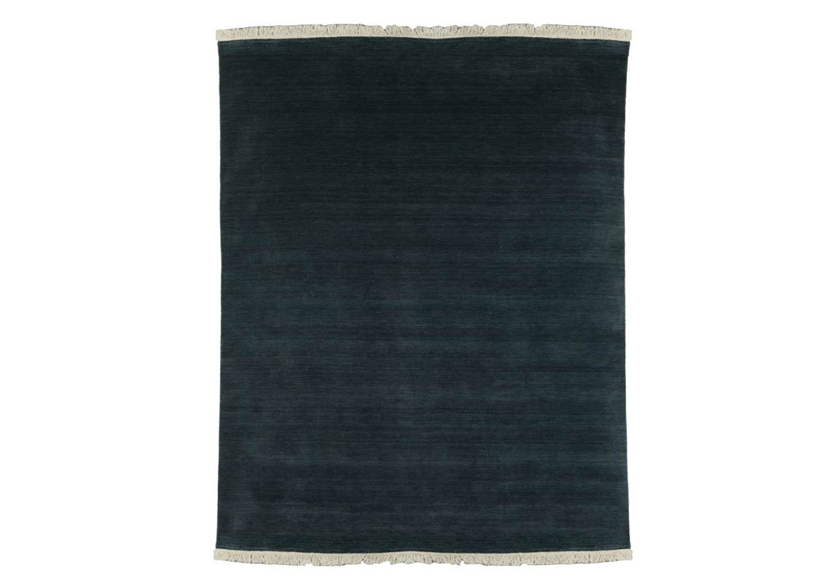 hand loomed rug. large jasper, denim blue rug. with fringe one the ends.