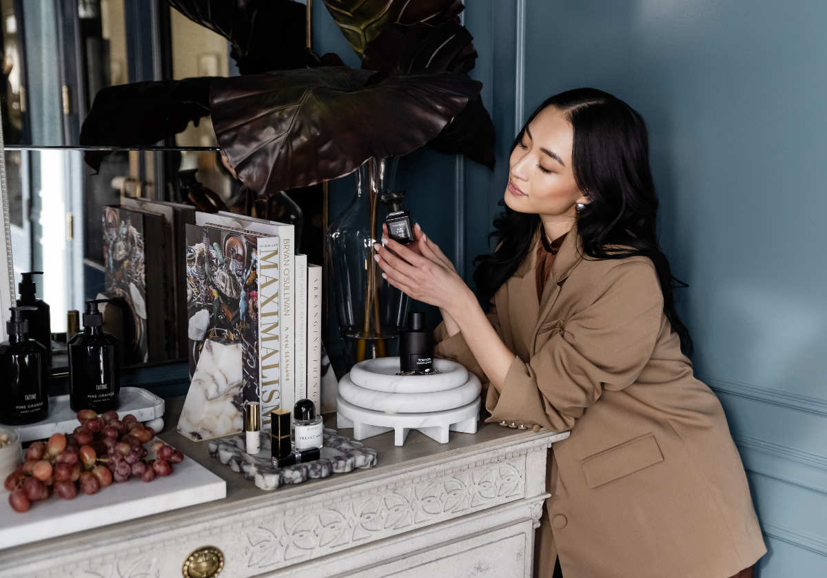 marble bookends, and dolce bowl seen on a dresser top. with model holding products. 