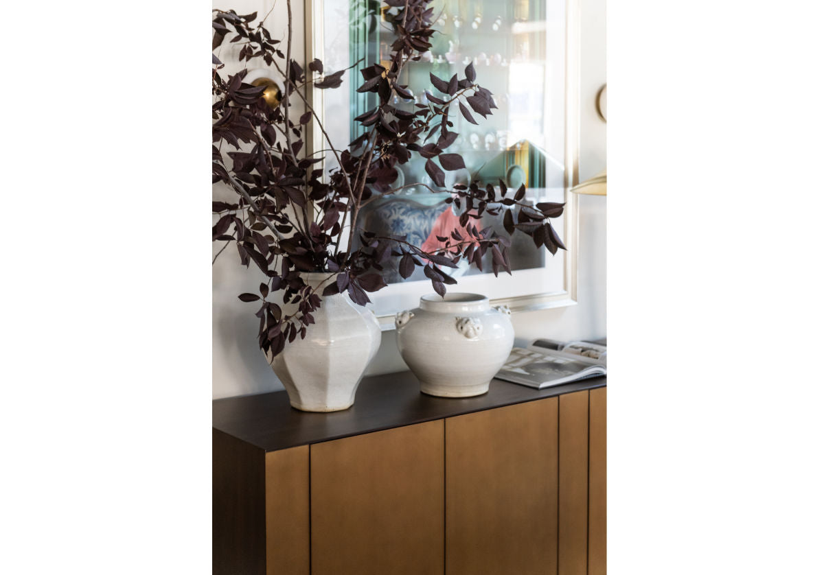 lifestyle photo of agnes white jar next to another vase on a cabinet. 