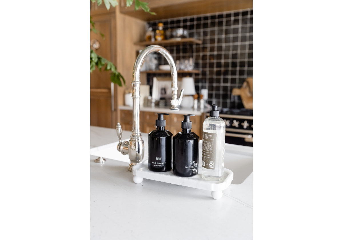 lifestyle photo of grand marble footed tray sitting on kitchen counter. 