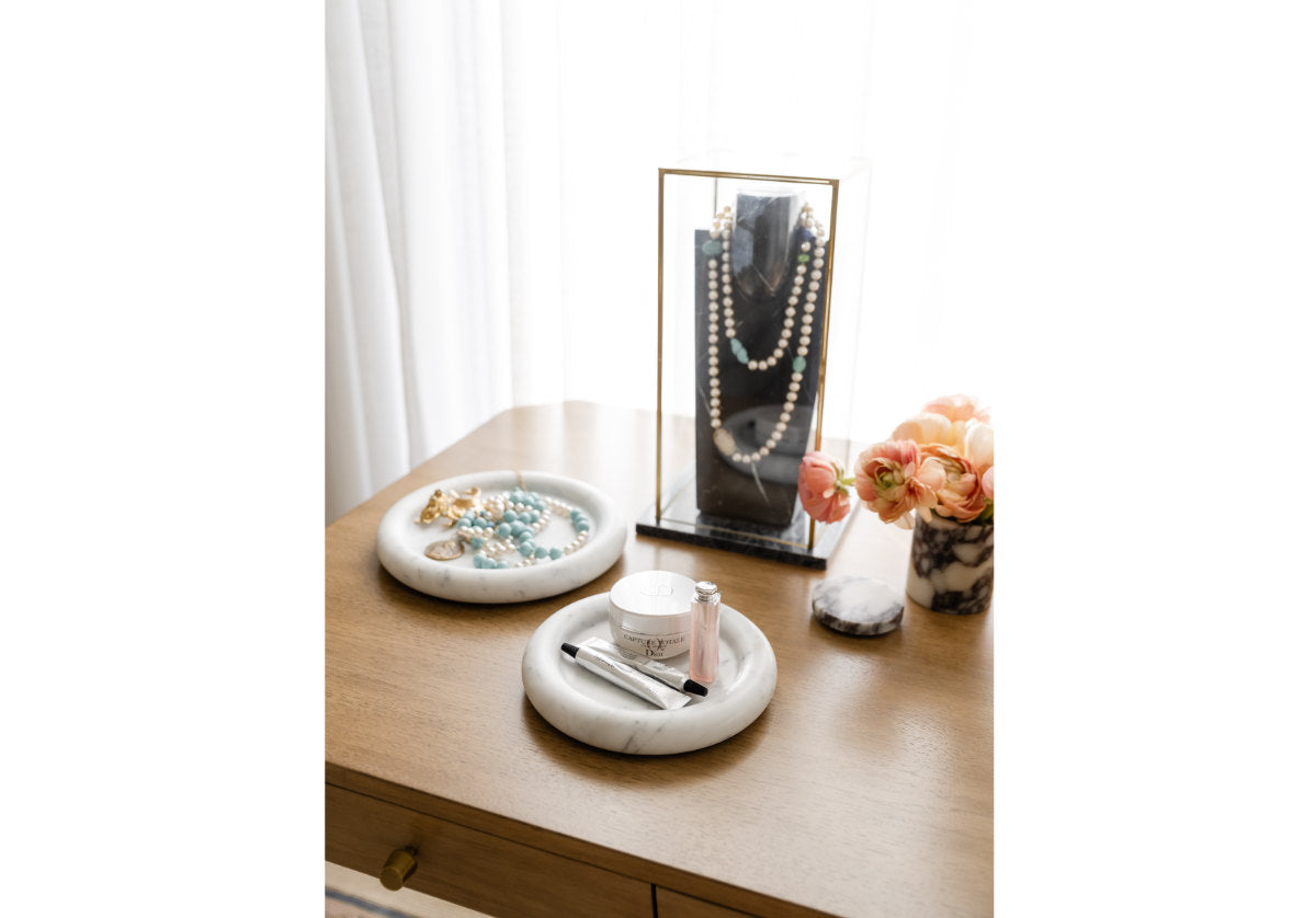 both small and large milan dishes can be seen here ona. dresser. holding jewelry and the other holding makeup. 