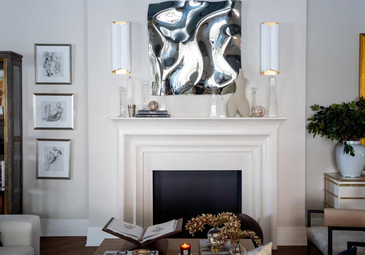 five different sized obelisks can be seen on top of a fireplace mantle with some crystal candlesticks and other decorative items.