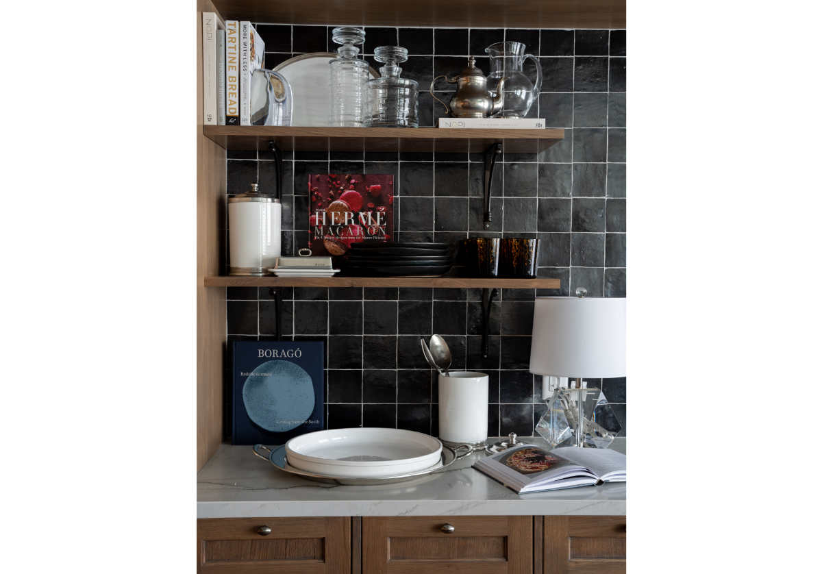 small birdie lamp in a kitchen scene next to a large white bowl and gray backsplash. 