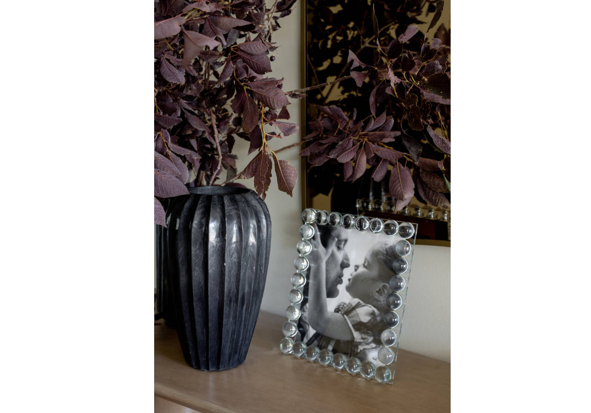 black flora vase on a console with the crystal orb frame 