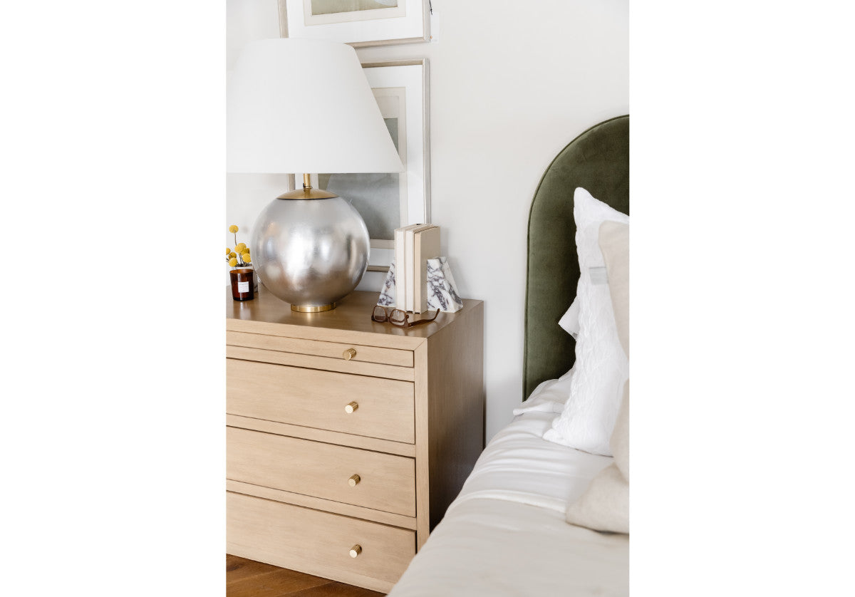 small brooklyn dresser can be seen in a lifestyle photo with the kit bed and a large silver lamp on top. 