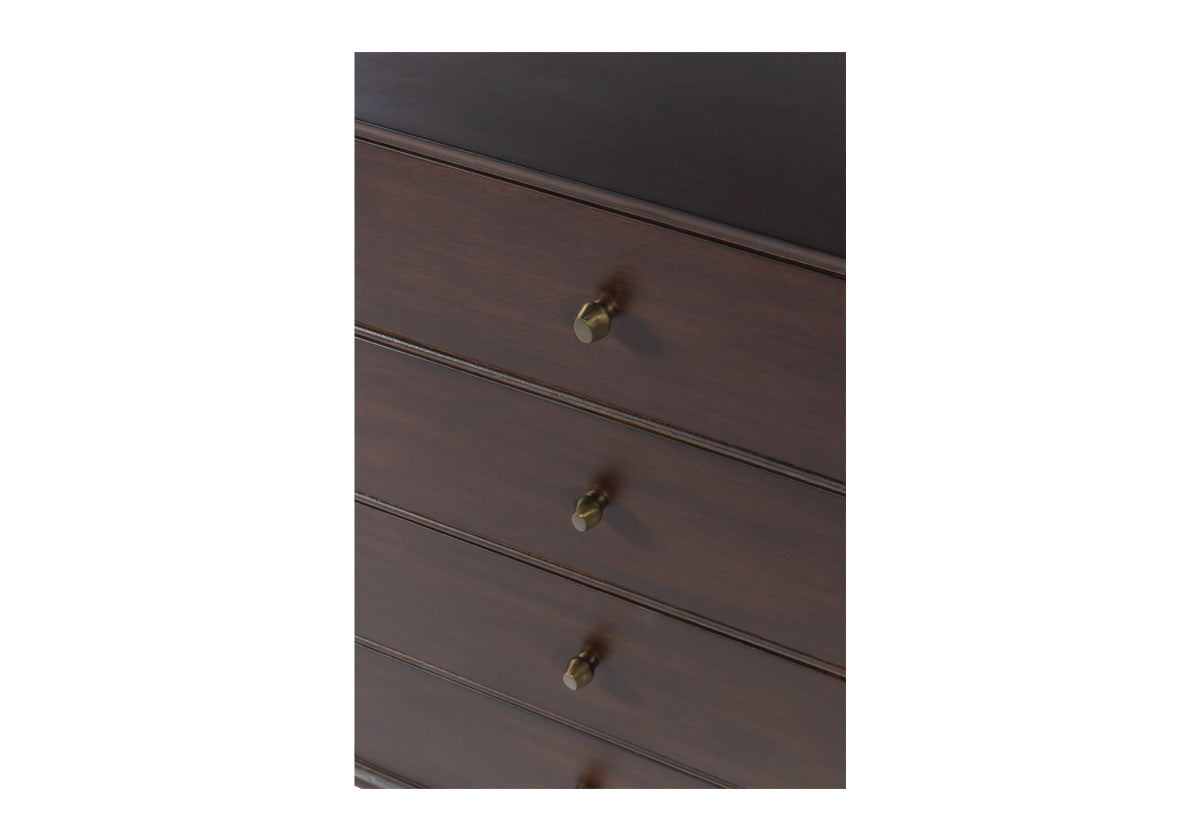 close up of frank drawers all closed. The Frank Sideboard gives an elevated, mid-century feel with its handsome design. Its dark mahogany box, doors, and drawers add a rich sophistication to any room. Organic-shaped bronzed knobs provide additional dimension complemented by ample hidden storage. Style in a living room, dining room, office, or bedroom for a one-of-a-kind design.