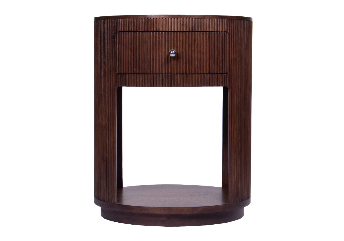 This nightstand is a tasteful addition, effortlessly styling into bedrooms with its petite size. Crafted from solid walnut, reeded accents run down the frame for a textured, dimensional look. Its minimal design features clean lines beautifully contrasted by a rounded base and one drawer with nickel hardware.