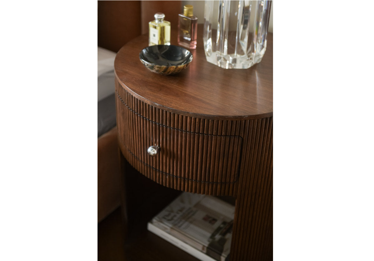 top down lifestyle photo of the cleo nightstand with the base of the beverly lamp next to the kit bed. 