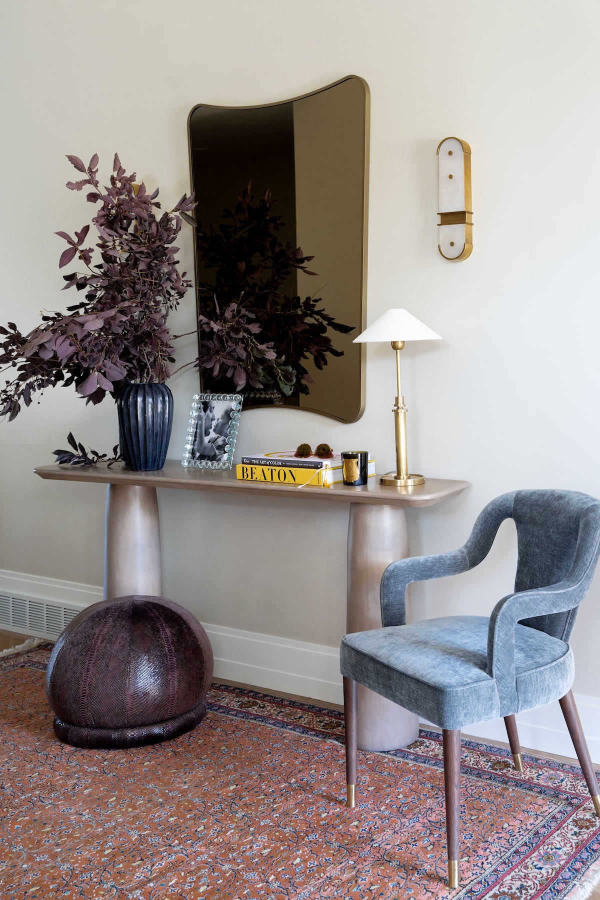 the domino sconce next to a mirror and above a table lamp. 