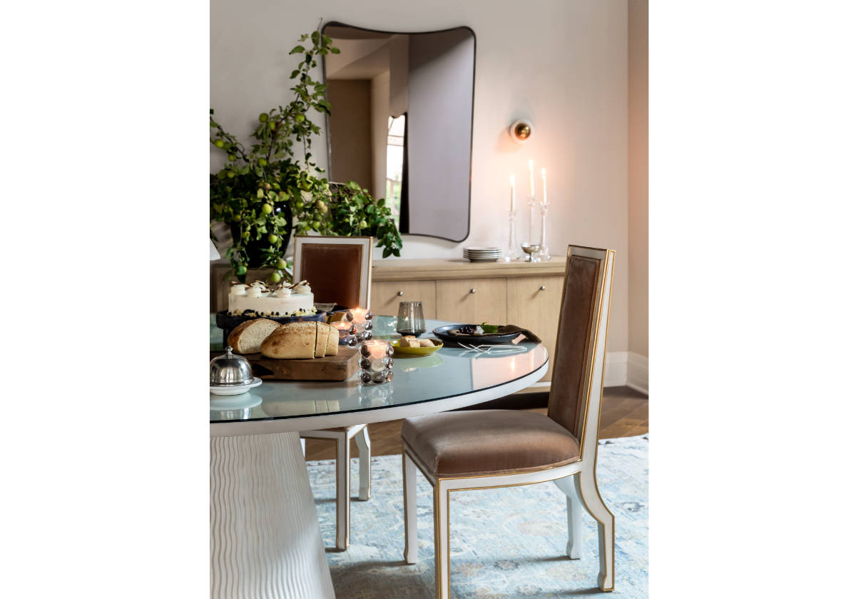 the lennon votive can be seen on the lucca dining table with the felix mirror next to it. 