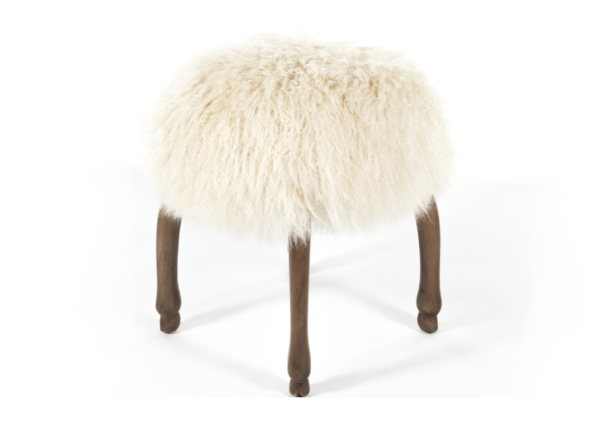 product photo of fifi accent stool with its long, luxurious Mongolian sheepskin seat elevated by four animal hoof feet.