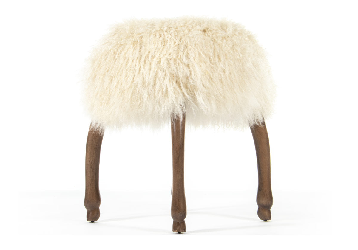 side product photo of fifi accent stool with its long, luxurious Mongolian sheepskin seat elevated by four animal hoof feet.