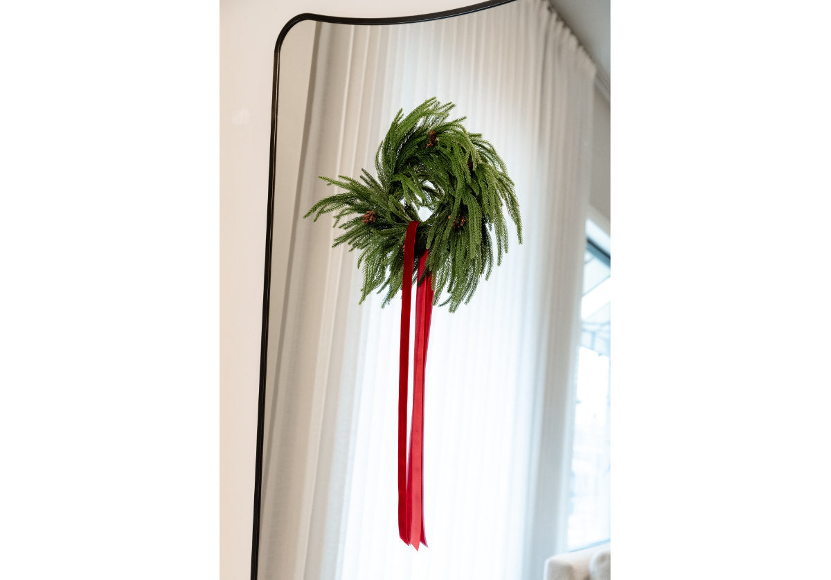 a fir wreath on a mirror. 
