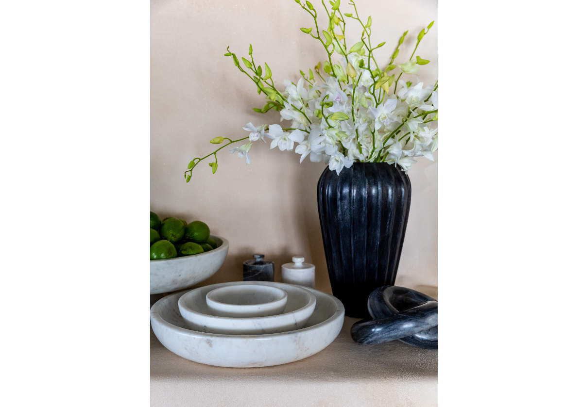 lifestyle photo of the komo knot sitting in front of the flora vase and marble bowls. 